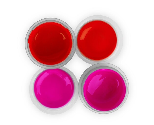 Red and pink paints in a jar on a white background