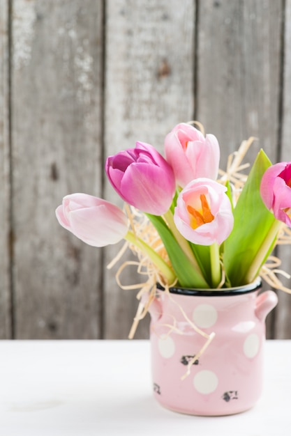 Red pink tulips on rustic background