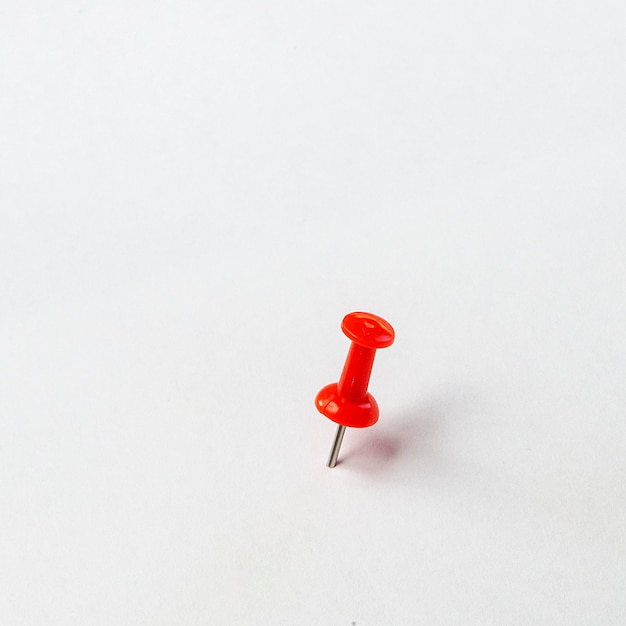 Photo red plastic push pin isolated on white background