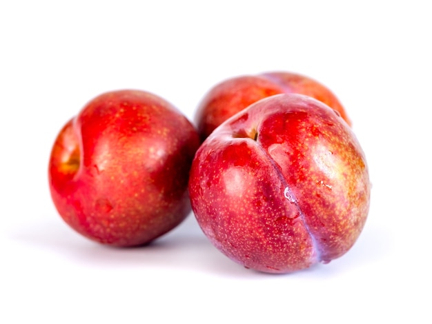 Red plums isolated on the white, fruit