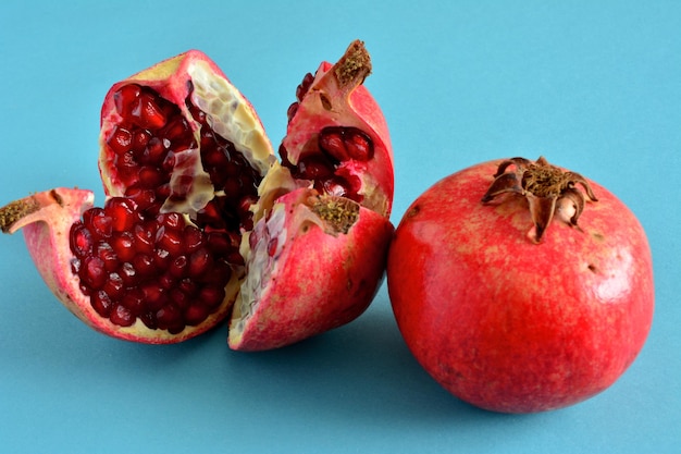 red pomegranate isolated with halves of fruit, close-up