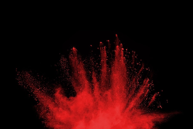 Red powder explosion isolated on black 