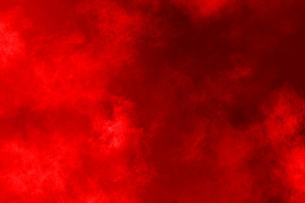 Red powder explosion on red background