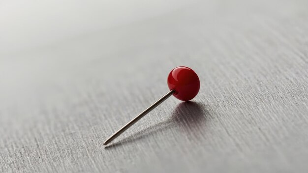 Photo red push pin on white surface