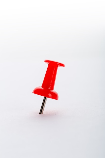 Red pushpin closeup isolated on white