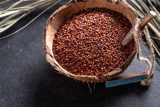 red quinoa on dark texture