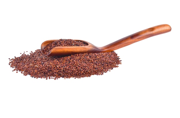 Red quinoa seeds in wooden spoon isolated on white background