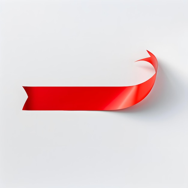 Photo a red ribbon curved and pointed upwards on a white background