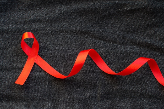 Photo red ribbon with world aids day concept.