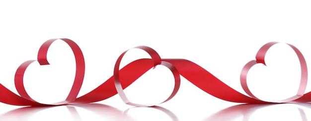 Red ribbons in shape of hearts isolated on white