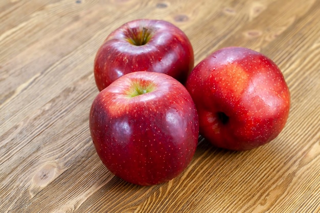 A red ripe apple cut into pieces on the table