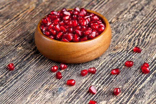 Red ripe pomegranate seeds in a plate