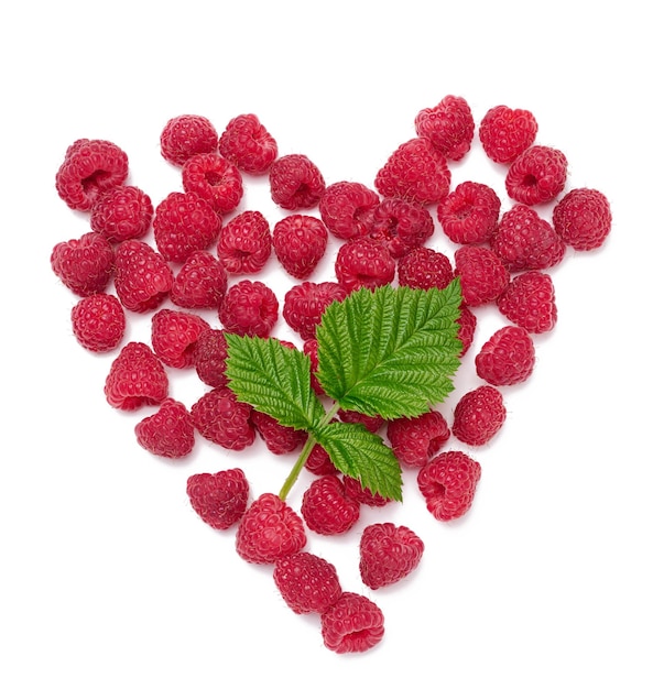 Red ripe raspberries and green leaves on a white background