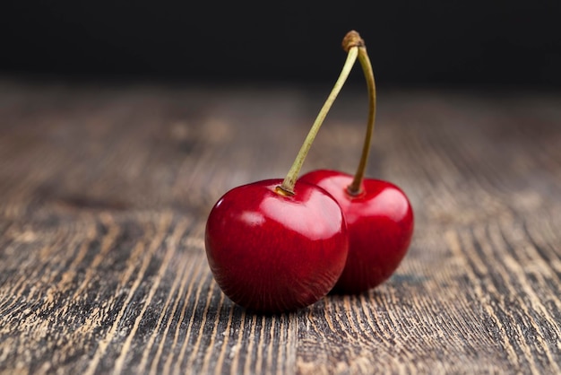 Red ripe sweet cherries on a wooden table