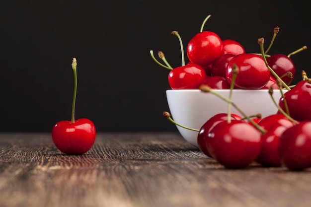 Red ripe sweet cherries on a wooden table