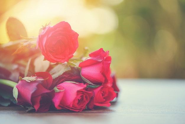 Red rose flower bouquet Pink and red roses love on wooden table nature background Valentines day for lover