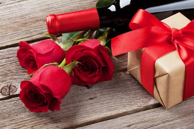 Red rose flowers wine and gift box