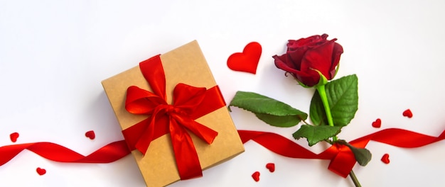 Red rose and gift box with ribbon for Valentine's day.