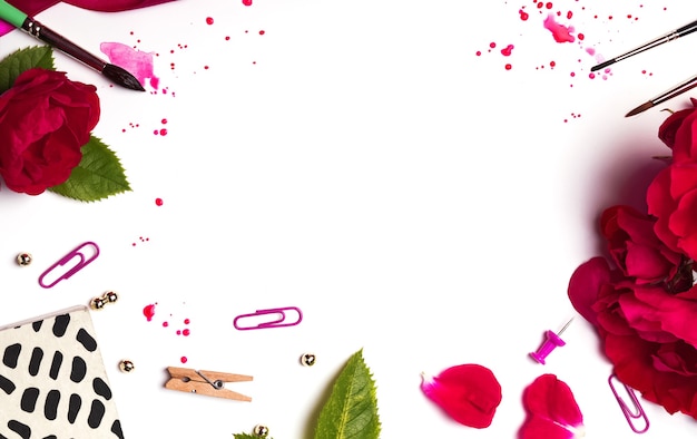 Red roses, brushes, petals and paint splashes