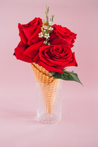 Red roses in Ice Cream on pink, copy space