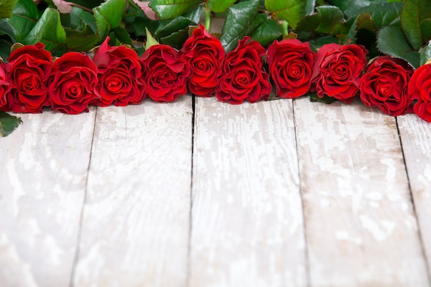 Red roses on wooden board