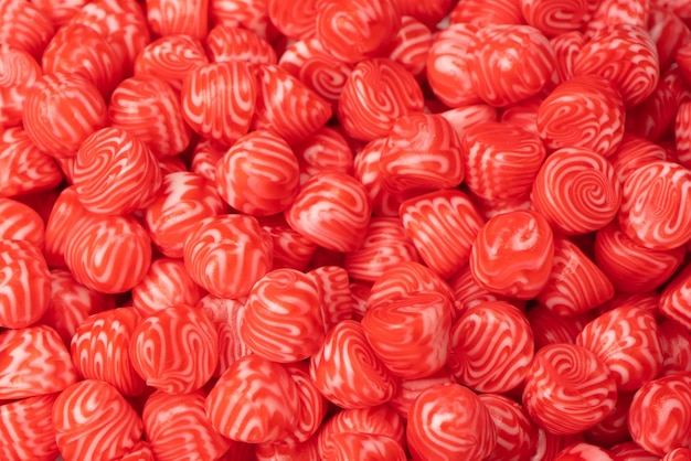 Red round tasty gummy candies as a background