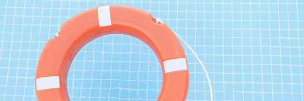 Red safety equipment floating on swimming pool to rescue people from drowning