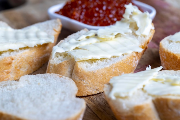 Red salmon or trout caviar with white baguette and butter