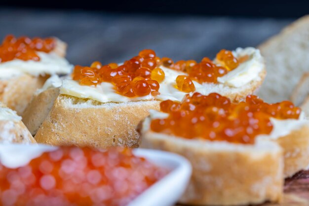 Red salmon or trout caviar with white baguette and butter