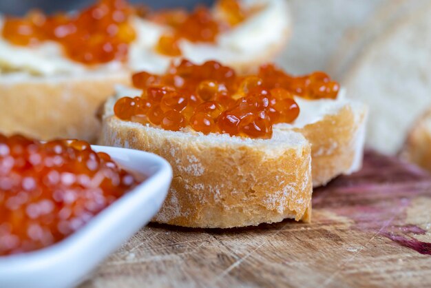 Red salmon or trout caviar with white baguette and butter