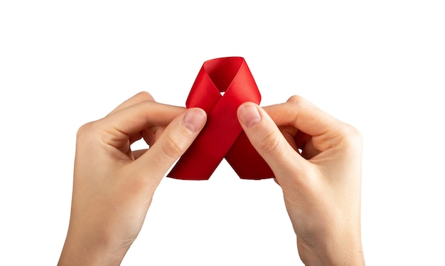 Red satin ribbon in hand isolated on white background HIV and AIDS awareness day symbol