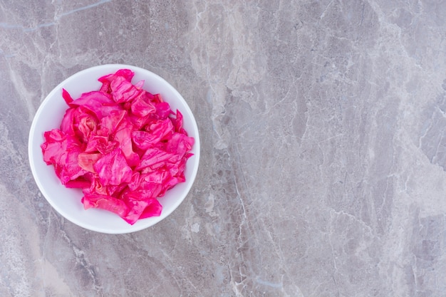 Red sauerkraut in a bowl, on the marble.