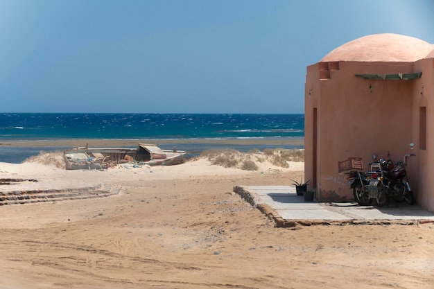 Red sea House on the shore with an abandoned boat