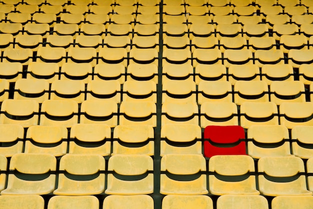 Red seat in Yellow Seat Pattern in Football Stadium