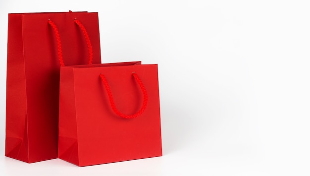 Red shopping bags isolated on the white background. Copy space