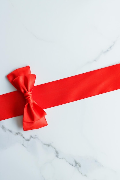 Red silk ribbon on marble top view