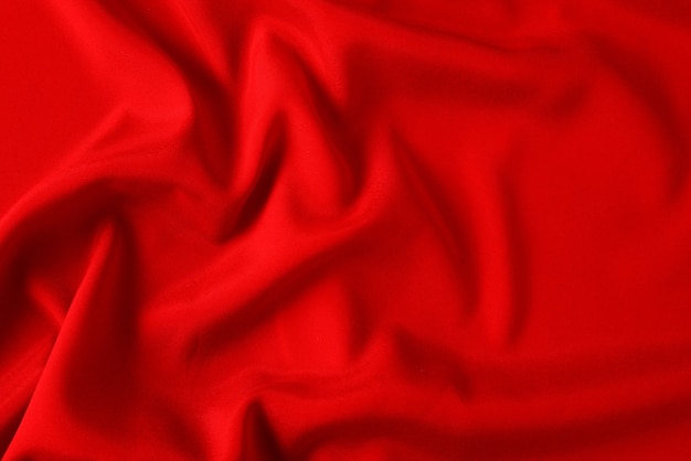 Red silk or satin luxury fabric texture can use as abstract background. Top view