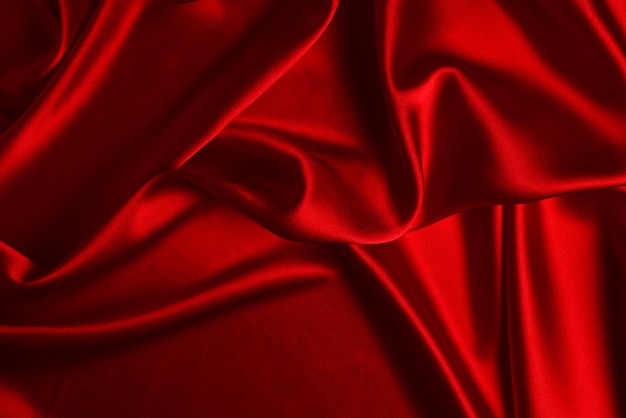 Red silk or satin luxury fabric texture can use as abstract background Top view