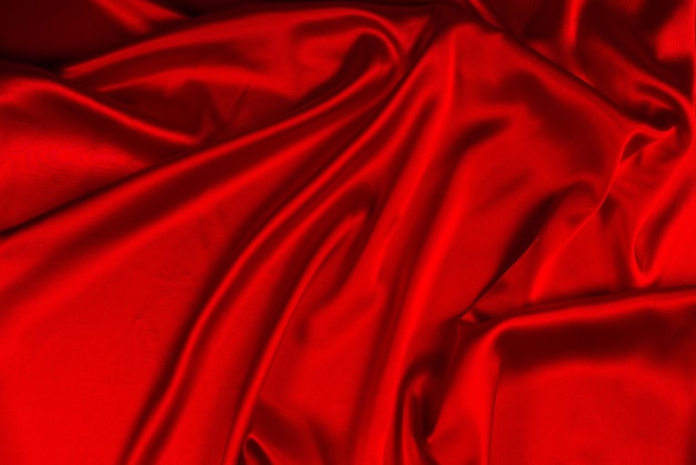 Red silk or satin luxury fabric texture can use as abstract background Top view