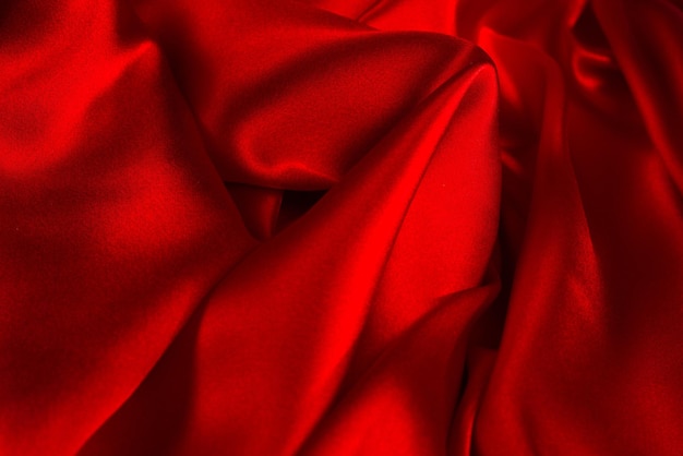 Red silk or satin luxury fabric texture can use as abstract background Top view