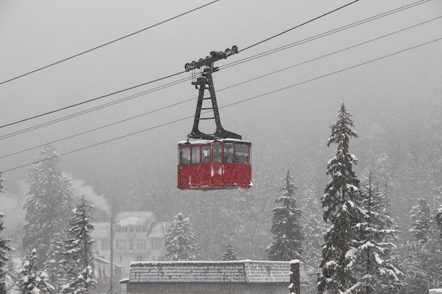 Red skilift cabine in the strong snowfall in the mountains of the Caucasus