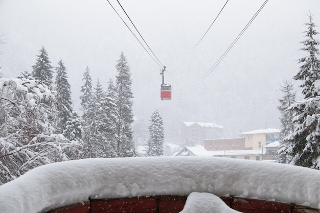 Red skilift cabine in the strong snowfall in the mountains of the Caucasus