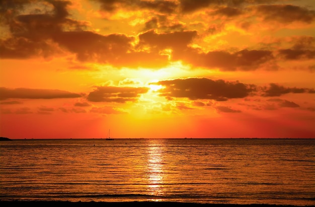 Red sky in Alghero shoreline on a cloudy sunset