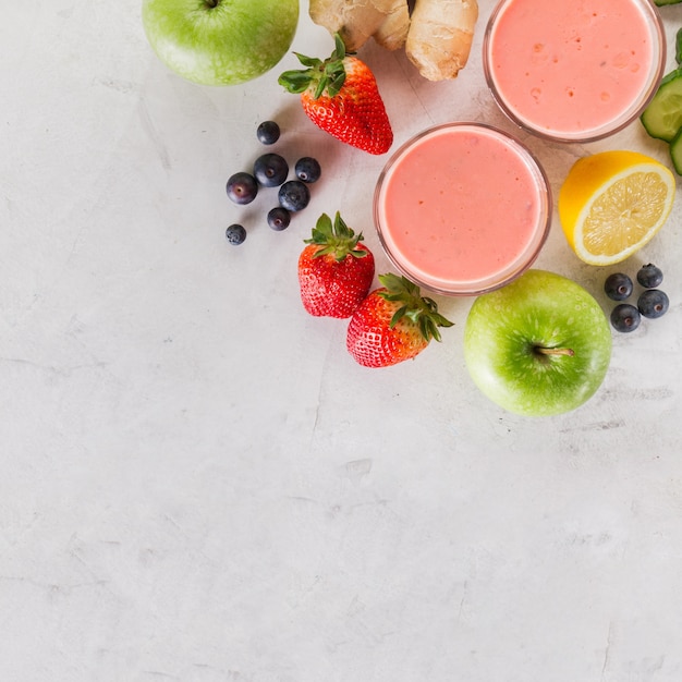 Red smoothie with ingredients close up