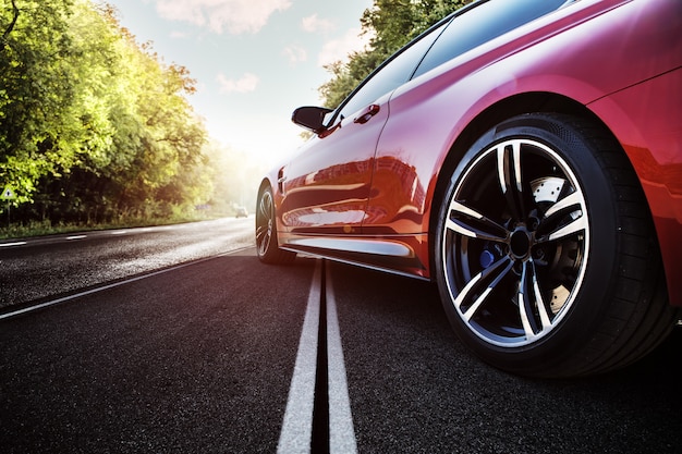 Red sport car on the asphalt road