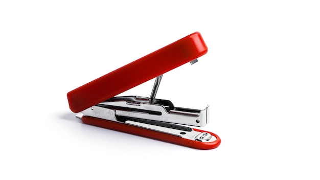 Red stapler on a white background. High quality photo