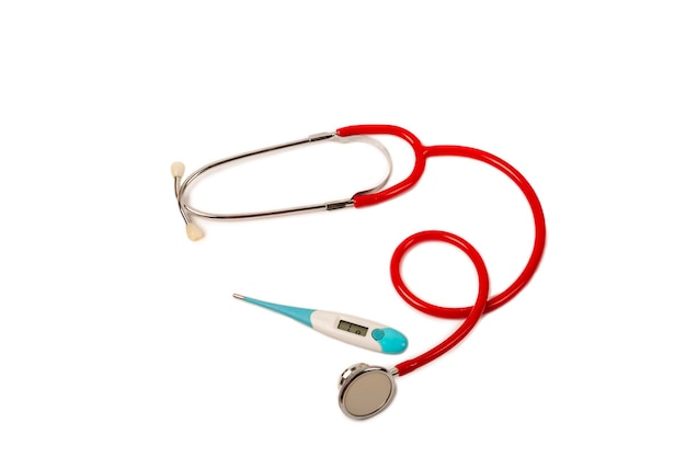 Red stethoscope thermometer isolated on white background Flat lay with different medical doctor objects equipment supplies on white isolation Close up copy space Medical and cardiology concept