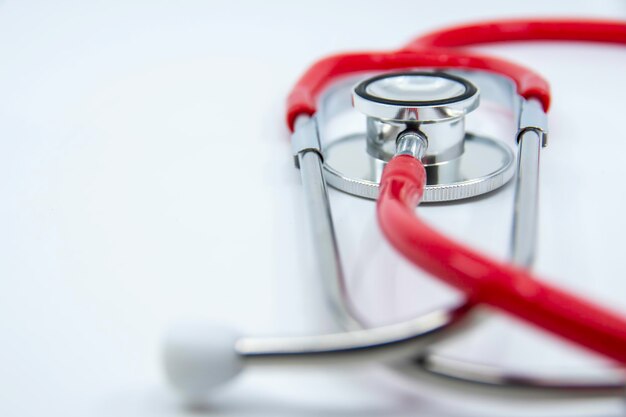 Red stethoscope on white background Medical devices For treatment Healthcare concept Copy space f