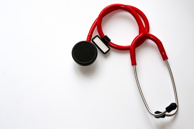 Red stethoscope with black membrane and white sticker isolated on white background