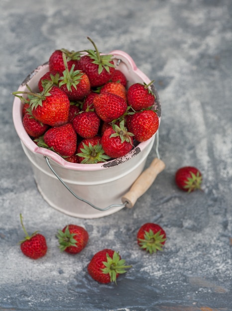 Red strawberies in a wooden bowl